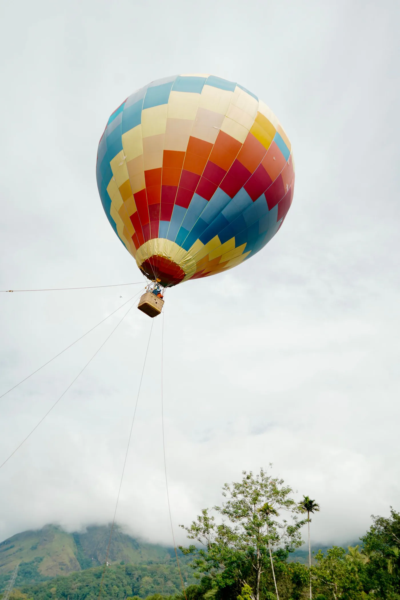 Hot air balloon flying above a mountain landscape